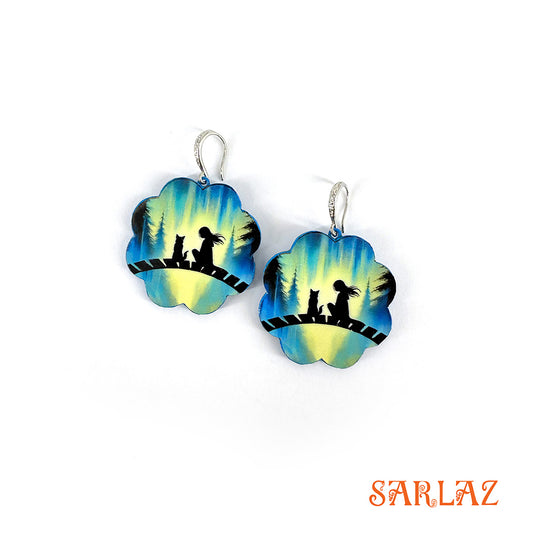 Floral-shaped earrings with a silhouette of a girl and her dog design on an aurora colour background, featuring the brand 'SARLAZ'.