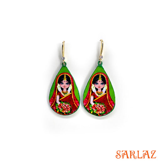 Teardrop-shaped earrings with a colourful design of a bride is shown in full Indian bridal attire, carrying a heritage rich in ceremonial motifs and symbolic meaning., branded 'SARLAZ'.