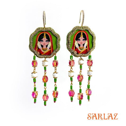 Colorful earrings with an Indian bride portrait design on a white background, featuring the brand 'SARLAZ'.