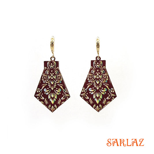 Decorative earrings with gold patterns on a white background, featuring the brand 'SARLAZ'.