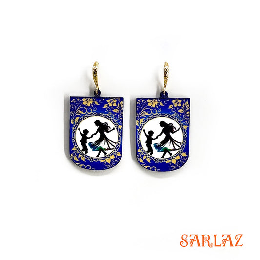 Pair of earrings with blue floral design and silhouette figures of a mother and her son dancing on a white background, branded 'SARLAZ'.