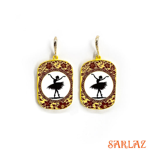 Pair of earrings with ballerina design on a white background, featuring the brand 'SARLAZ'.