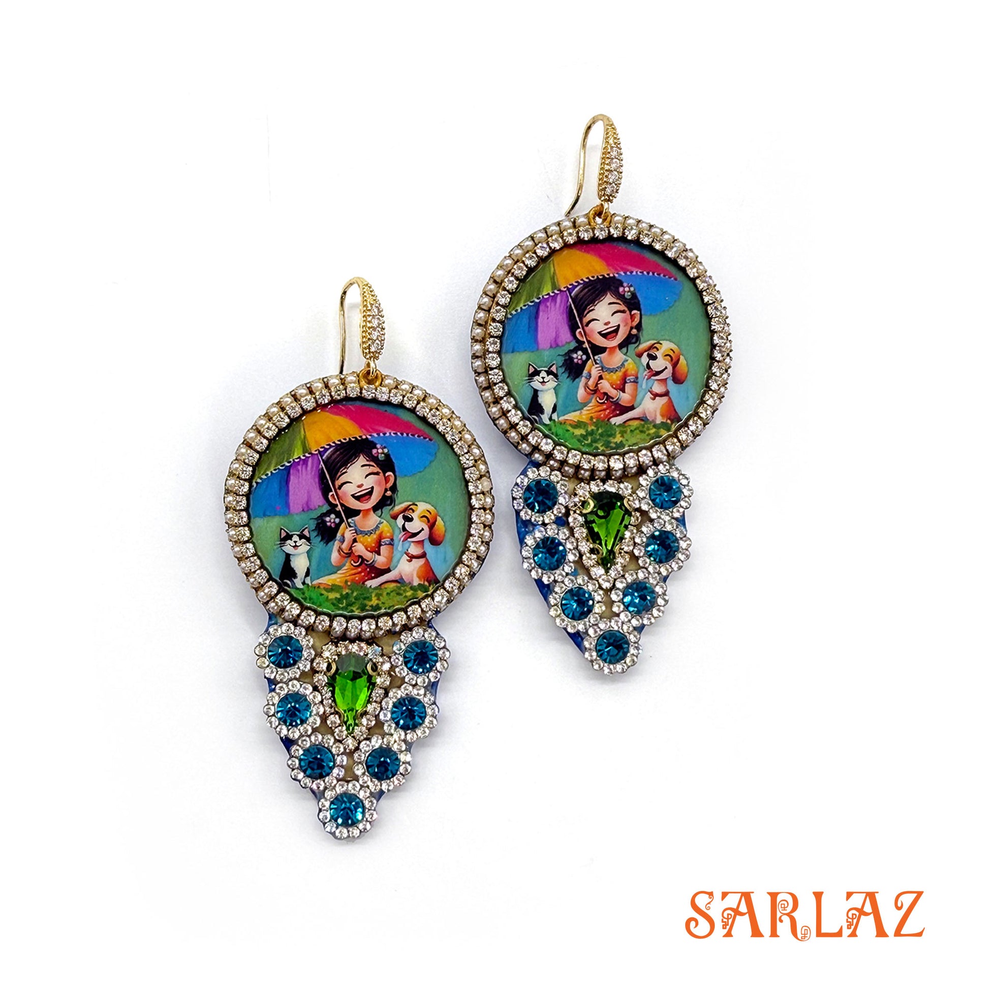 Colorful earrings with art of a girl, her cat and dog, on a white background, featuring the brand 'SARLAZ'.