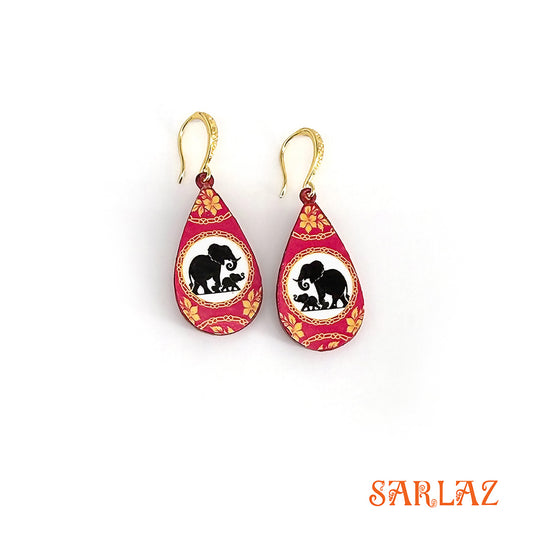 Pair of earrings with elephant and calf silhouette walking design on a white background, featuring the brand 'SARLAZ'.