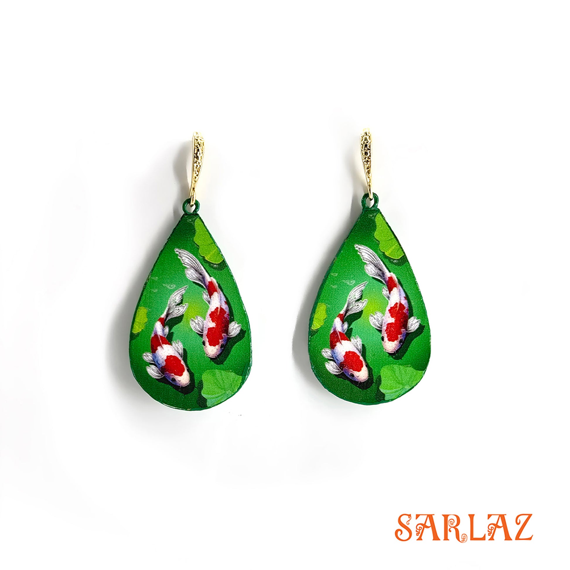 Teardrop-shaped earrings with koi fish design on a green background, brand 'SARLAZ' visible.
