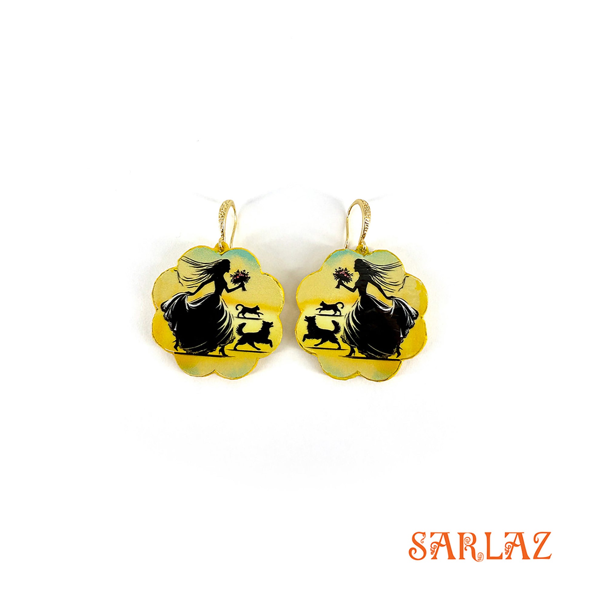 Pair of earrings with silhouettes of a bride with her cat and dog design on a yellow background, branded 'SARLAZ'.