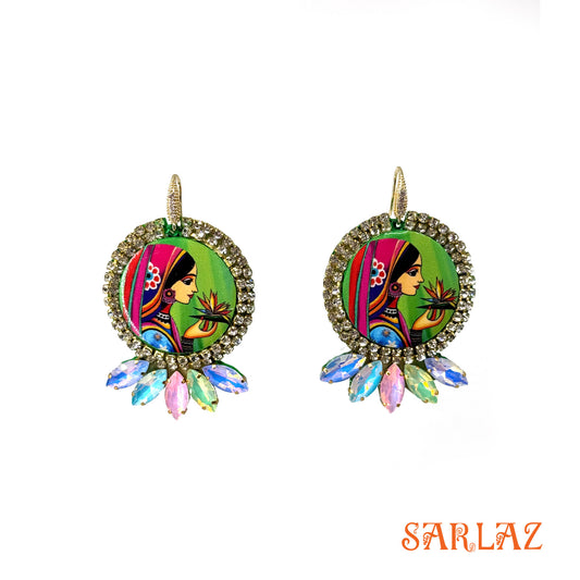 Colorful earrings with a woman's face design and rhinestone accents on a white background, featuring the brand 'SARLAZ'.