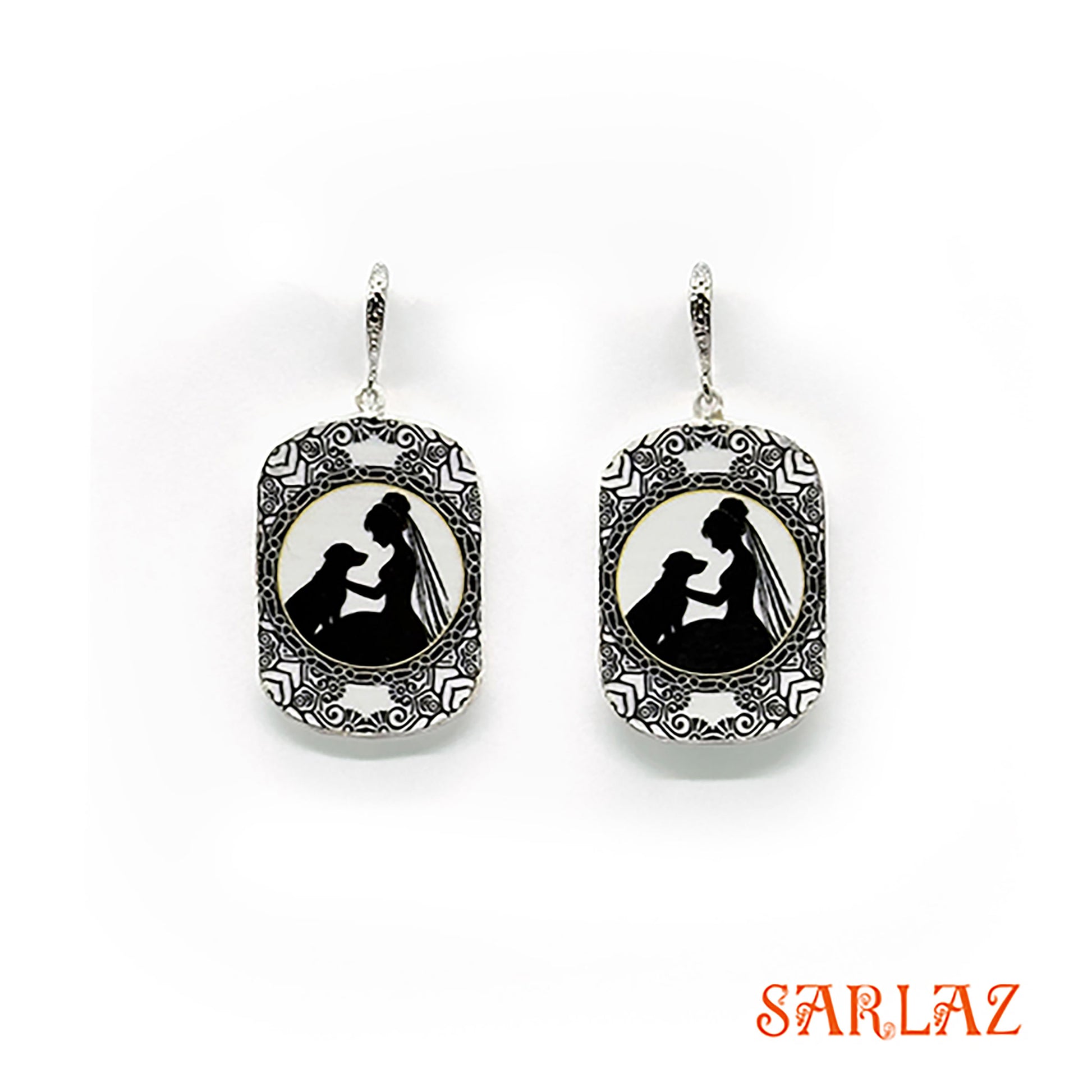 Pair of earrings with a silhouette design of a bride and her dog, branded 'SARLAZ', on a white background.