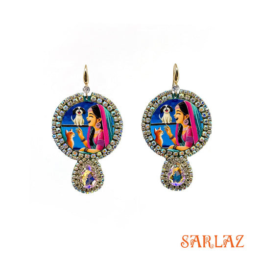 Decorative earrings with a colourful design featuring a girl, a puppy and a cat. Branded 'SARLAZ'.