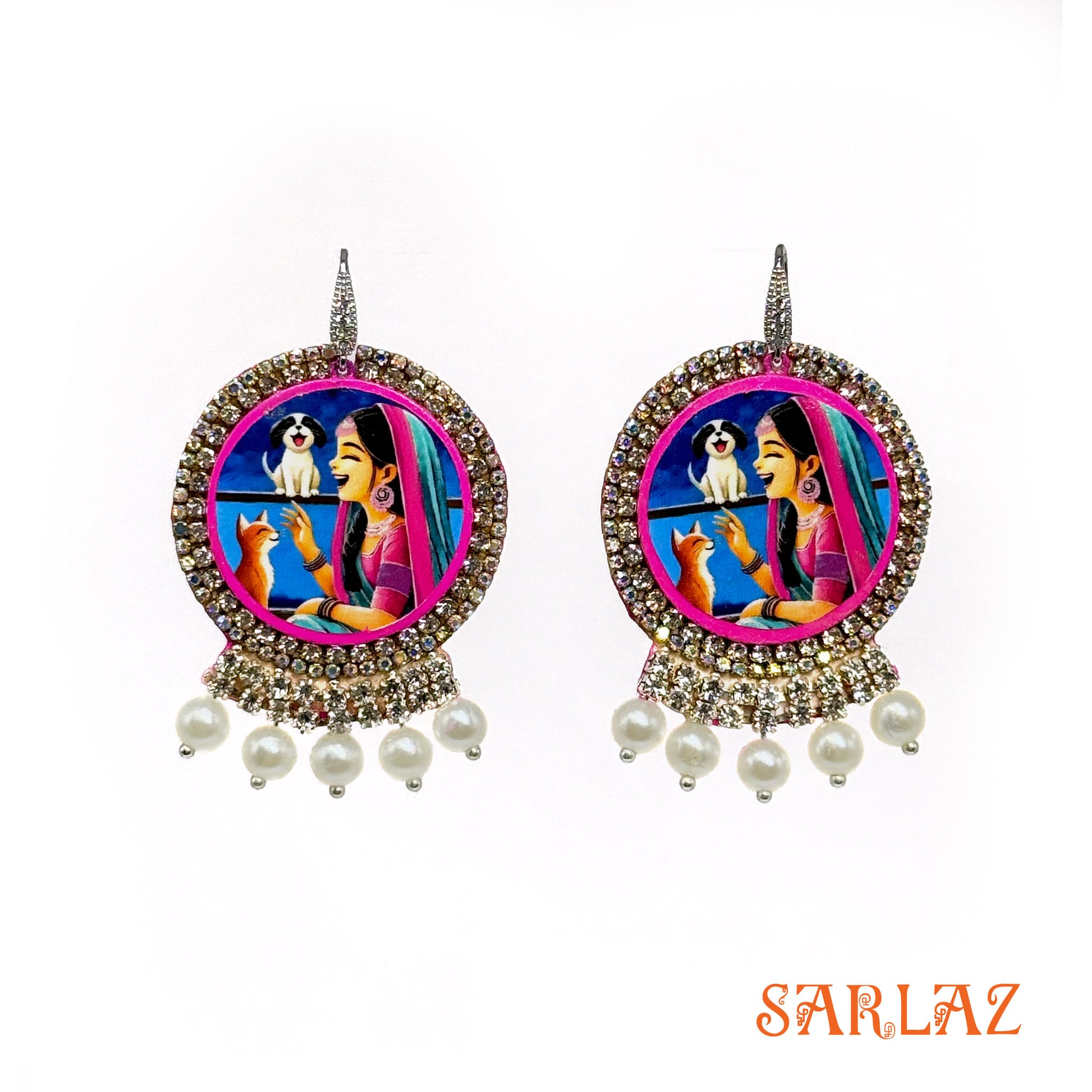 Decorative earrings with a colorful design featuring a woman, dog, and cat, branded 'SARLAZ'.
