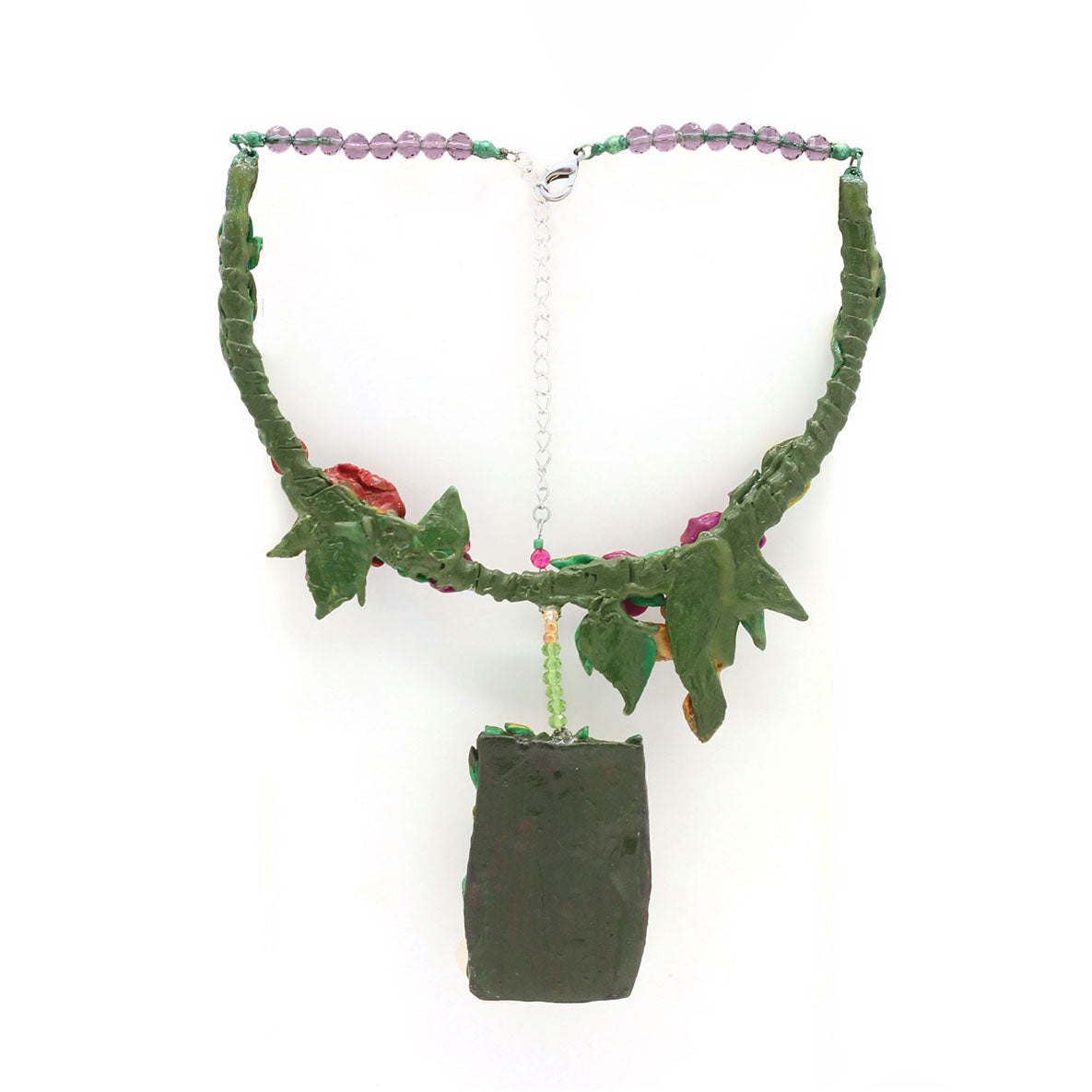 Dog Nature statement necklace, the design on the necklace captures the happy moment of a dog admiring a bird in the garden. A design by SARLAZ