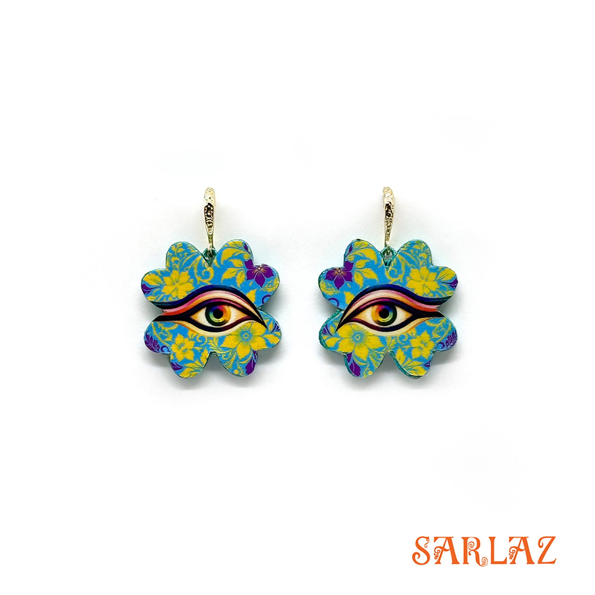 Colorful floral earrings, each four-leaf clover bursts with electric blue and golden yellow, forming patterns that seem to shift and breathe with a life of their own. At the heart rests the ever-watchful eye, framed by petals that radiate both joy and vigilance. 