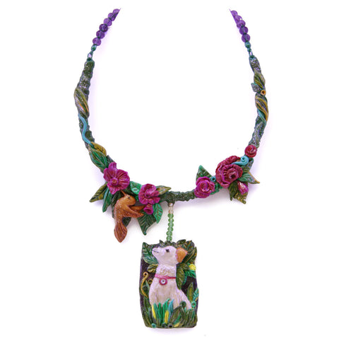 Dog Nature statement necklace, the design on the necklace captures the happy moment of a dog admiring a bird in the garden. A design by SARLAZ